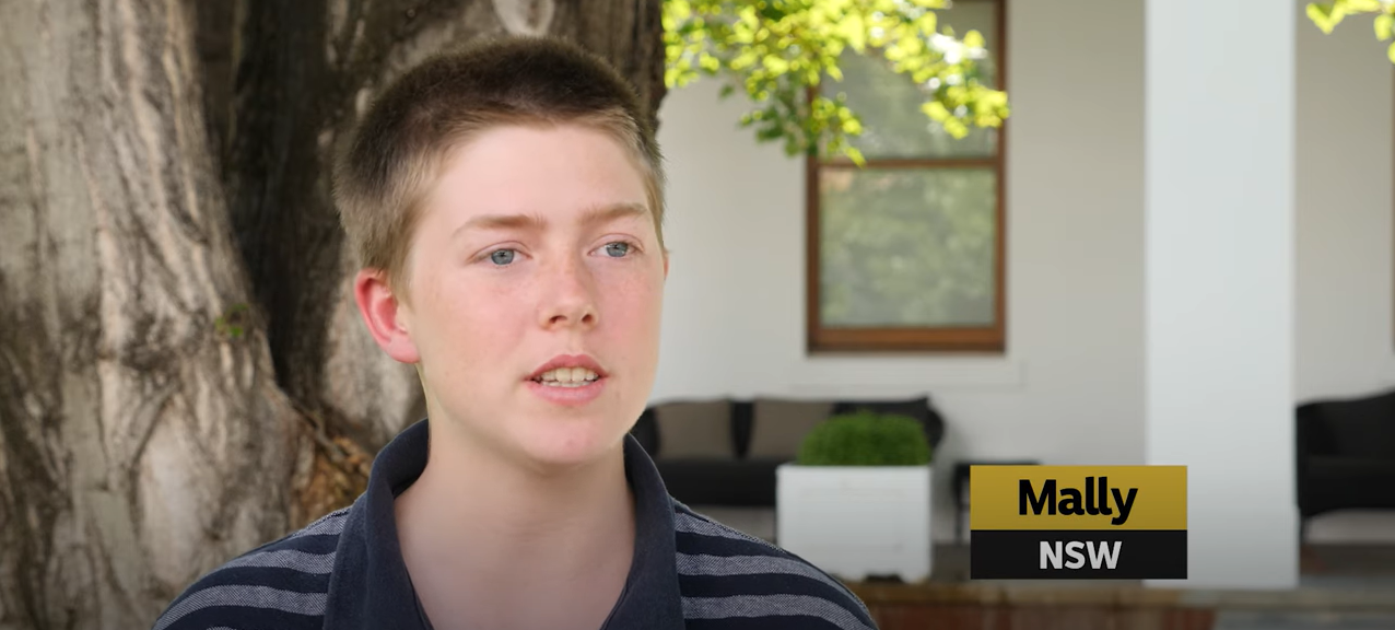 A still from a video with the portrait of a young person in high school speaking to the camera. 