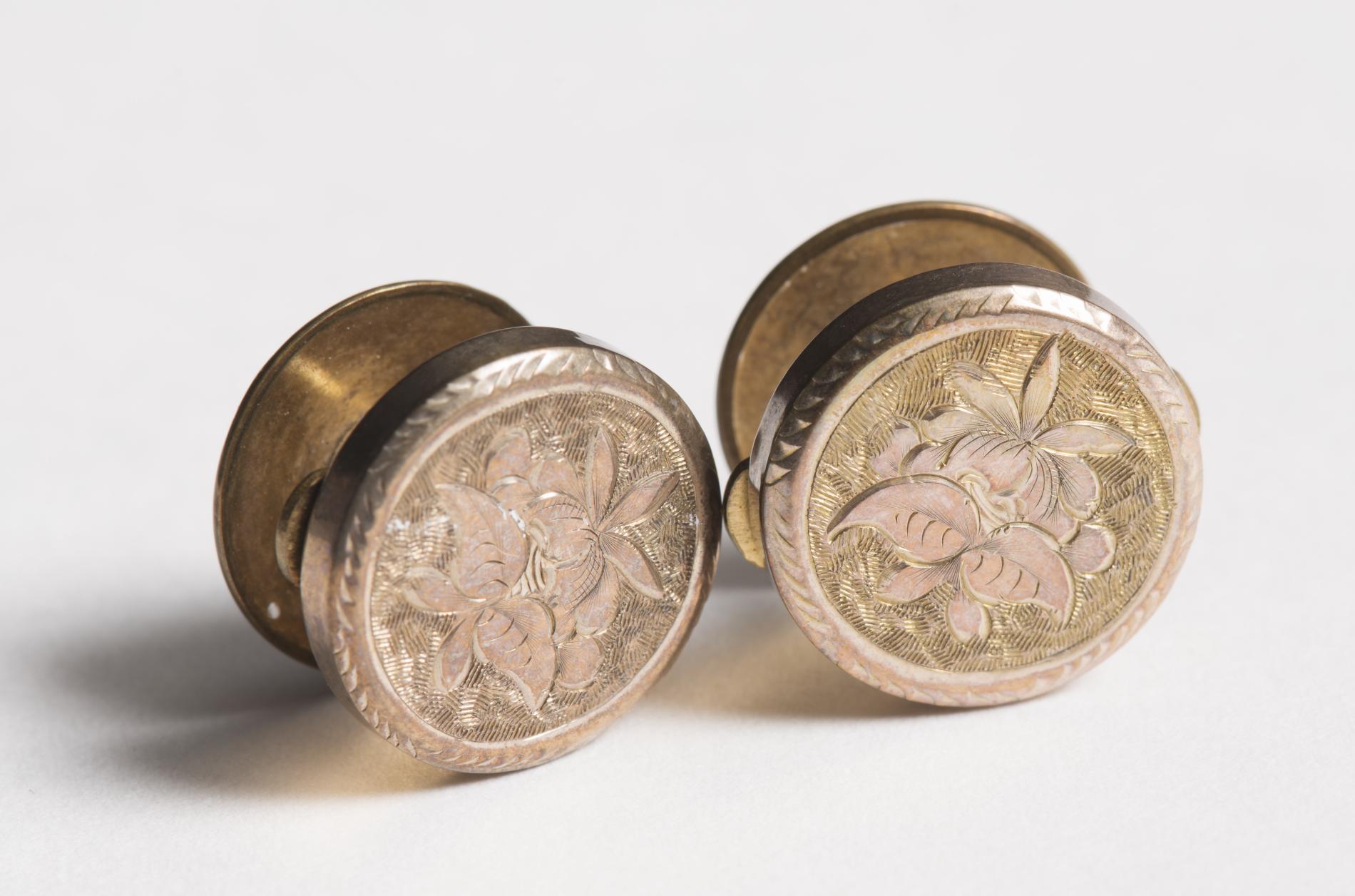 Photograph of two brass coloured cufflinks Photograph of two brass coloured cufflinks