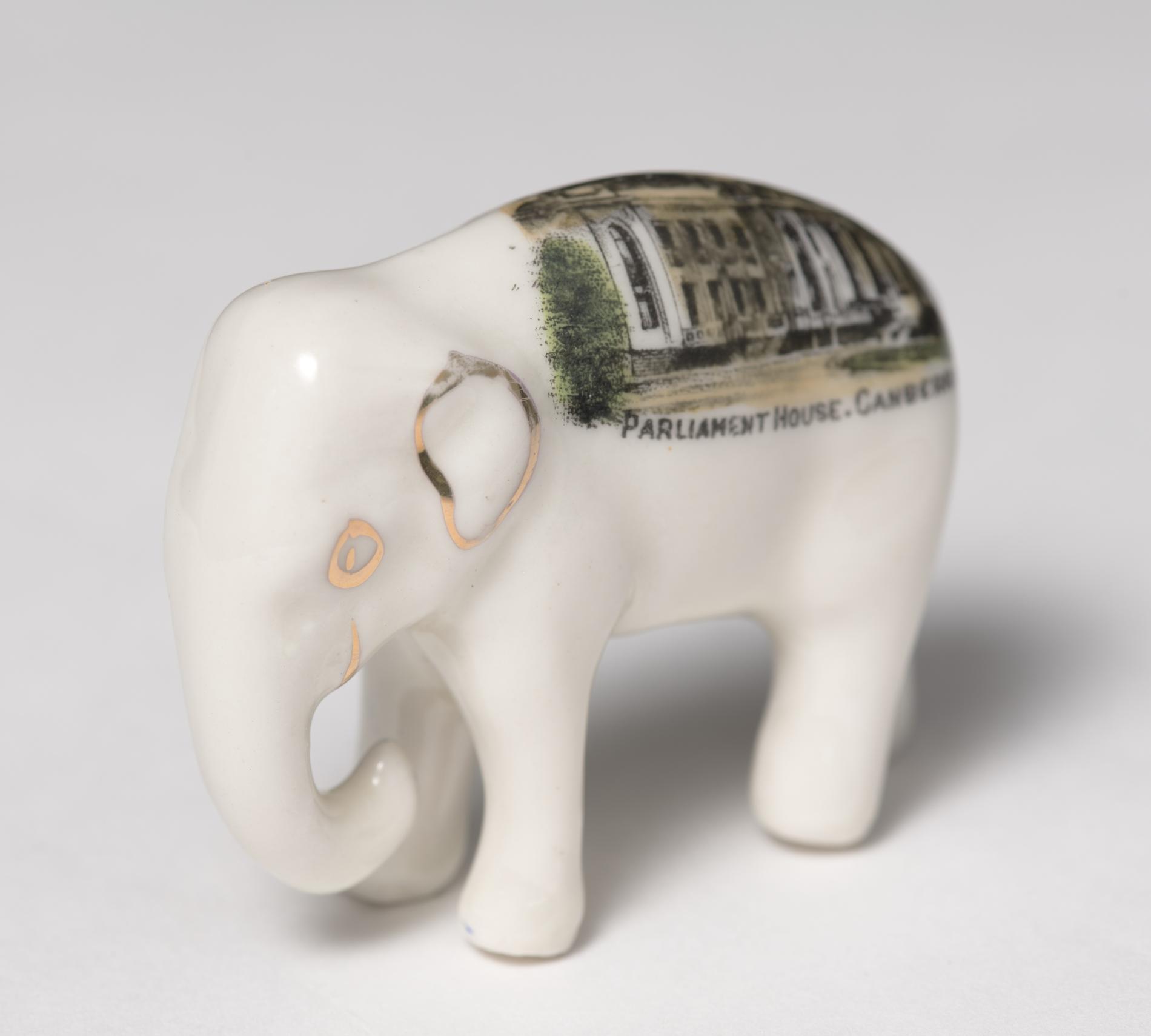 Photograph of a small, white ceramic elephant Photograph of a small, white ceramic elephant