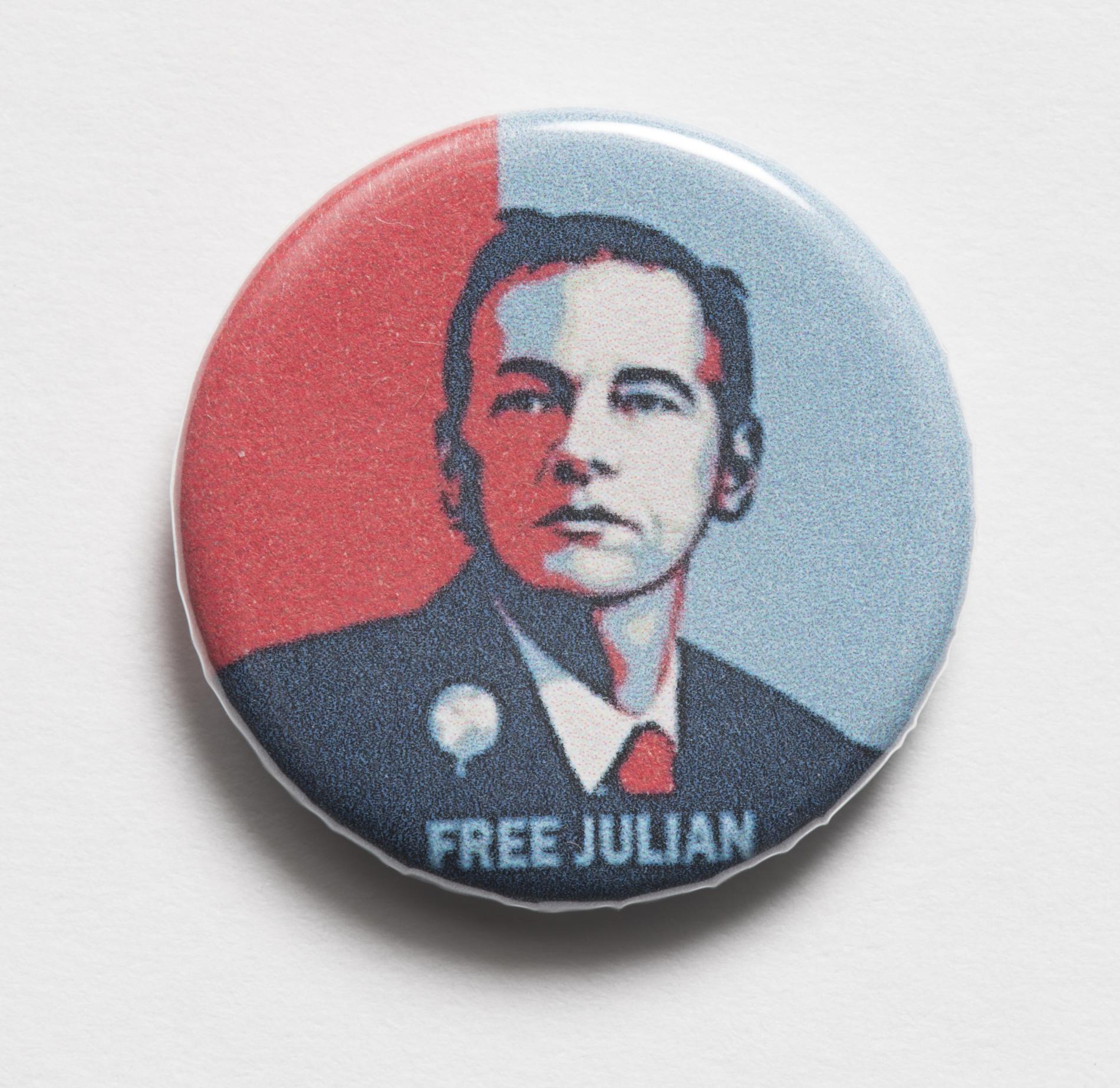 Photograph of a small badge labled "Free Julian" Photograph of a small badge labled "Free Julian"