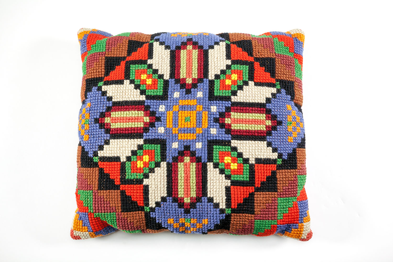 A square embroidered multicoloured cushion with a geometric pattern. A square embroidered multicoloured cushion with a geometric pattern.