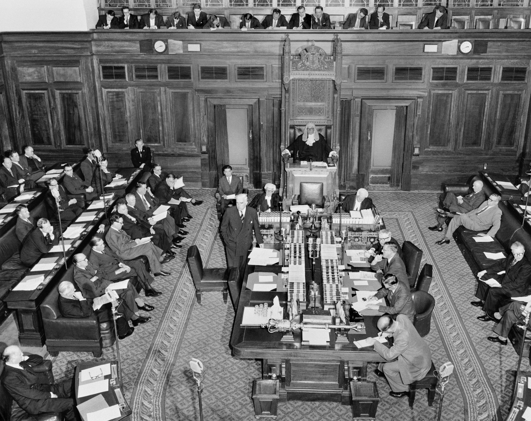 Parliamentarians sit in the House of Representatives at Old Parliament House in 1957. Sir Robert Menzies stands next to the centre table. Parliamentarians sit in the House of Representatives at Old Parliament House in 1957. Sir Robert Menzies stands next to the centre table.